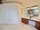 Bathroom boasts granite vanity, modern lighting, tile floors, and ample storage, providing an elegant and practical space at 5615 Oxford Moor Blvd, Windermere, FL 34786