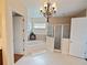 Elegant bathroom with chandelier lighting, soaking tub, glass shower, and tile floors, creating a luxurious space at 5615 Oxford Moor Blvd, Windermere, FL 34786