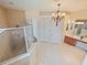 Spacious bathroom features a glass-enclosed shower, double sink vanity, and tile flooring, offering a functional design at 5615 Oxford Moor Blvd, Windermere, FL 34786