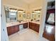 Elegant bathroom with double vanity, soaking tub, and decorative mirrors provide a spa-like experience at 5615 Oxford Moor Blvd, Windermere, FL 34786