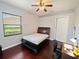 Comfortable bedroom featuring hardwood floors, a ceiling fan, and a window with blinds at 5615 Oxford Moor Blvd, Windermere, FL 34786