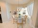Bright breakfast nook features a round glass table, decorative chandelier, and views to the screened lanai at 5615 Oxford Moor Blvd, Windermere, FL 34786