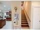 Foyer featuring staircase, kitchen, neutral walls, and tiled floor offers a grand entrance and access to multiple rooms at 5615 Oxford Moor Blvd, Windermere, FL 34786