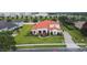 Aerial view of a well-maintained house with a terracotta roof and lush green lawn at 5615 Oxford Moor Blvd, Windermere, FL 34786