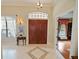 Welcoming foyer with elegant double doors, tile flooring, and a glimpse into the adjacent living space at 5615 Oxford Moor Blvd, Windermere, FL 34786