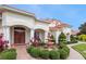 Stunning home featuring double doors, columns, and a well-manicured front yard at 5615 Oxford Moor Blvd, Windermere, FL 34786