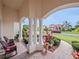 Charming front porch with rocking chairs, columns and manicured landscaping at 5615 Oxford Moor Blvd, Windermere, FL 34786