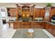 Gourmet kitchen showcases custom wood cabinetry, granite counters and backsplash, plus a large island at 5615 Oxford Moor Blvd, Windermere, FL 34786