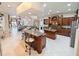 Spacious open-concept kitchen features custom cabinetry, a large island with seating, and stainless appliances at 5615 Oxford Moor Blvd, Windermere, FL 34786