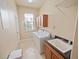 Bright laundry room features a window, washer, dryer, cabinets, and utility sink, providing a functional laundry space at 5615 Oxford Moor Blvd, Windermere, FL 34786