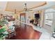 A spacious living room boasts hardwood floors, ceiling fans and a stone fireplace, creating a cozy and inviting atmosphere at 5615 Oxford Moor Blvd, Windermere, FL 34786