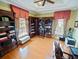 Spacious home office featuring custom wood built-in bookshelves and laminate floors at 5615 Oxford Moor Blvd, Windermere, FL 34786