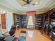 Well-appointed office featuring custom bookcases, natural light, and a classic wooden ladder at 5615 Oxford Moor Blvd, Windermere, FL 34786