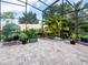 Enclosed patio featuring brick flooring and a variety of potted plants and greenhouse at 5615 Oxford Moor Blvd, Windermere, FL 34786