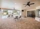 Covered patio featuring seating, a ceiling fan, and sliding doors to seamlessly blend indoor and outdoor living at 5615 Oxford Moor Blvd, Windermere, FL 34786