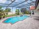 Backyard view of a pool area with connected hot tub and screened enclosure at 5615 Oxford Moor Blvd, Windermere, FL 34786