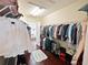 Spacious walk-in closet features custom shelving, hanging rods, and wood flooring, maximizing storage and organization at 5615 Oxford Moor Blvd, Windermere, FL 34786