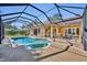 Wide shot of a backyard featuring a screened in pool and spa at 605 W Palm Valley Dr, Oviedo, FL 32765