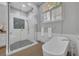 Well-lit bathroom with a large glass shower enclosure and modern soaking tub at 605 W Palm Valley Dr, Oviedo, FL 32765