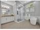 Bright bathroom featuring a glass shower, garden tub, and large window at 605 W Palm Valley Dr, Oviedo, FL 32765