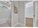 Bathroom and bedroom with connecting doorway, chandelier, and tub with shower at 605 W Palm Valley Dr, Oviedo, FL 32765