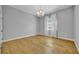 Bedroom with hardwood floors, a chandelier, and a window with white curtains at 605 W Palm Valley Dr, Oviedo, FL 32765