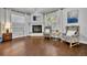 Bedroom sitting area with fireplace, hardwood floors, and two comfortable chairs at 605 W Palm Valley Dr, Oviedo, FL 32765