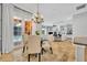 Charming dining area showcases a chandelier, tile floors, and views into the living room and outdoor pool at 605 W Palm Valley Dr, Oviedo, FL 32765