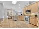 Well-appointed kitchen with stainless steel appliances, tile floors, and adjacent dining area at 605 W Palm Valley Dr, Oviedo, FL 32765