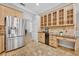 Kitchen features stainless steel appliances, granite countertops, and wood cabinets with glass fronts at 605 W Palm Valley Dr, Oviedo, FL 32765