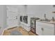 Laundry room with a washer and dryer, a utility sink, and stone floors at 605 W Palm Valley Dr, Oviedo, FL 32765