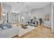 Bright living room with soaring ceilings, travertine floors, an elegant entry door, and stylish furniture at 605 W Palm Valley Dr, Oviedo, FL 32765