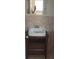Modern bathroom featuring a vanity sink with a wooden cabinet and travertine tile on the walls at 7028 Clarcona Ocoee Rd., Orlando, FL 32818