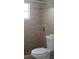 Bathroom featuring a tiled shower, updated fixtures, and a modern toilet at 7028 Clarcona Ocoee Rd., Orlando, FL 32818