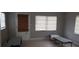 Cozy bedroom featuring neutral walls, tile flooring, a door to the exterior and natural light at 7028 Clarcona Ocoee Rd., Orlando, FL 32818