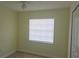 Bright bedroom featuring neutral walls, tile flooring and a window for natural light at 7028 Clarcona Ocoee Rd., Orlando, FL 32818