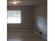 Cozy bedroom featuring neutral walls, carpet flooring and a large window for natural light at 7028 Clarcona Ocoee Rd., Orlando, FL 32818