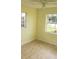 Bright bedroom featuring neutral walls, tile flooring and two large windows for natural light at 7028 Clarcona Ocoee Rd., Orlando, FL 32818