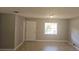Bright living area featuring neutral walls, tile flooring and a large window for natural light at 7028 Clarcona Ocoee Rd., Orlando, FL 32818