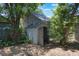 View of backyard with shed and lush surroundings, providing ample storage and privacy at 735 N Clara Ave, Deland, FL 32720