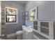 Bathroom with stylish vanity, ample storage, and sleek mirror, lit by natural light from a window at 735 N Clara Ave, Deland, FL 32720