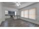 Open dining room with gray wood floors, white walls, and adjacent kitchen at 735 N Clara Ave, Deland, FL 32720