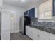 Modern kitchen features stainless steel appliances, white cabinets, and granite countertops at 735 N Clara Ave, Deland, FL 32720