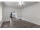 Spacious living room with gray wood floors, white walls, and picture frame wall molding at 735 N Clara Ave, Deland, FL 32720