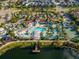 Aerial view of community amenities including a pool, lazy river, clubhouse, and sport courts at 8924 Bengal Ct, Kissimmee, FL 34747