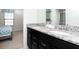 Bathroom with double granite vanity, and a view of the adjacent bedroom at 8924 Bengal Ct, Kissimmee, FL 34747