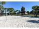 White sand beach volleyball court with a net in the background and lovely blue skies at 8924 Bengal Ct, Kissimmee, FL 34747