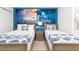 Comfortable bedroom featuring two twin beds, Star Wars decor, and a cozy atmosphere at 8924 Bengal Ct, Kissimmee, FL 34747