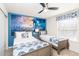 Comfortable bedroom featuring two twin beds, Star Wars decor, and a cozy atmosphere and ceiling fan at 8924 Bengal Ct, Kissimmee, FL 34747