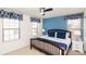 Inviting bedroom with matching navy blue decor, natural light and comfortable furnishings at 8924 Bengal Ct, Kissimmee, FL 34747